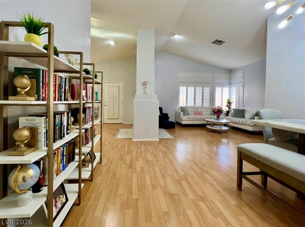 Image 4: A great room with soaring ceilings and light wood