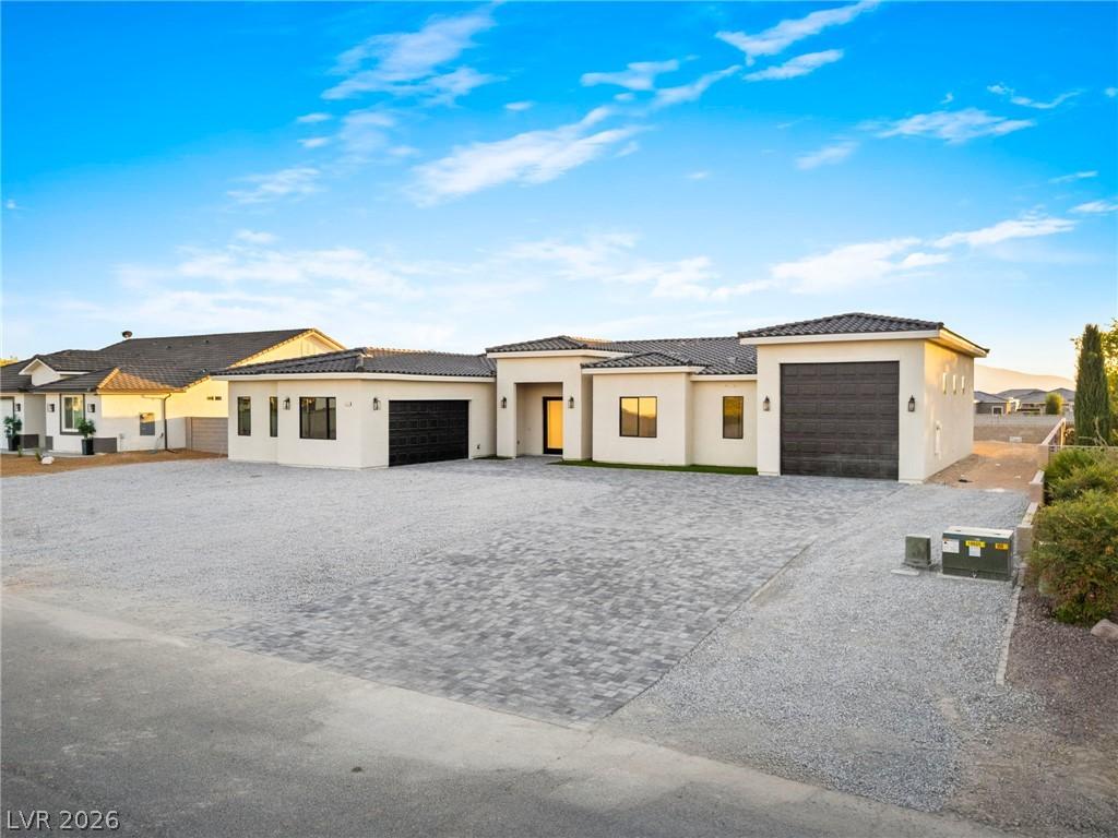 Image 4: A striking modern stucco residence with multiple g