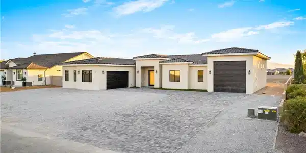 Image 4: A striking modern stucco residence with multiple g