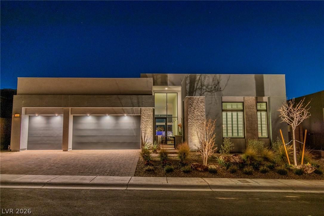 Image 1: An illuminated modern facade presents a striking w