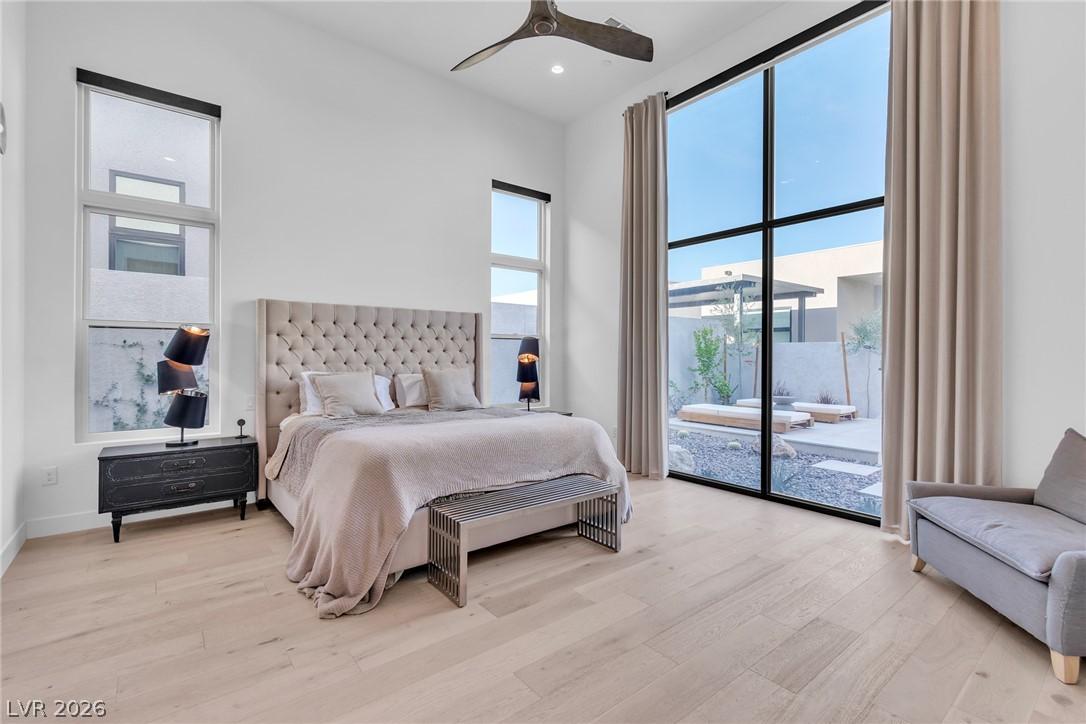 Image 4: Natural light floods this primary bedroom featurin