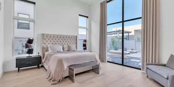 Image 4: Natural light floods this primary bedroom featurin