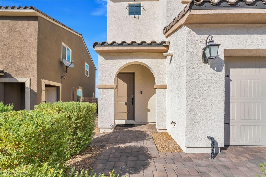 Image 4: Arched front door welcomes you from a charming pav