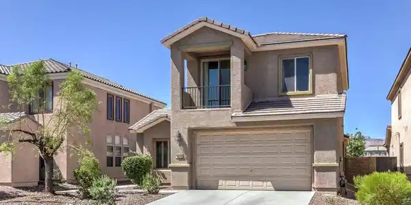 Image 2: Two-story stucco architecture featuring a concrete