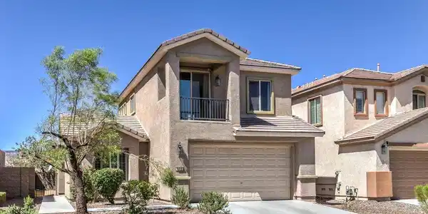 Image 3: An inviting exterior features a concrete driveway,