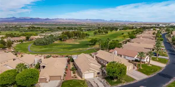 Image 3: Aerial perspective of suburban area with a golf cl