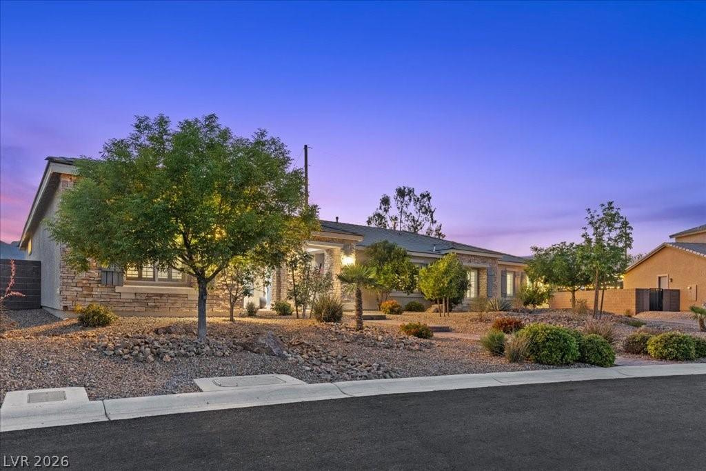 Image 2: Elegant exterior features a stone facade and metic