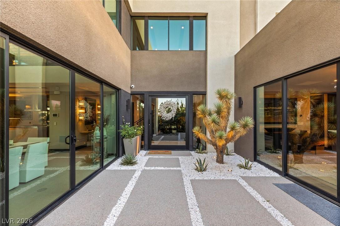 Image 4: A modern facade with expansive glass doors creates