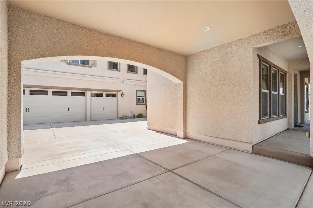 Image 4: A spacious concrete driveway leads to a welcoming