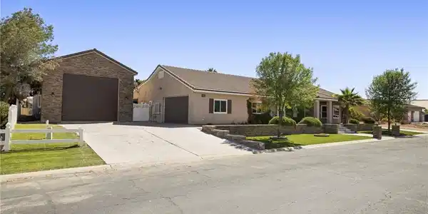 Image 3: A split driveway leads to a welcoming home featuri