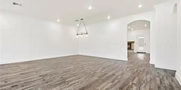Image 4: An open floorplan with durable flooring extends to