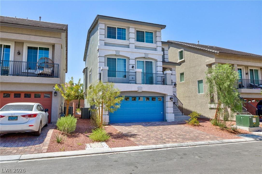 Image 2: A modern facade with striking blue garage doors an