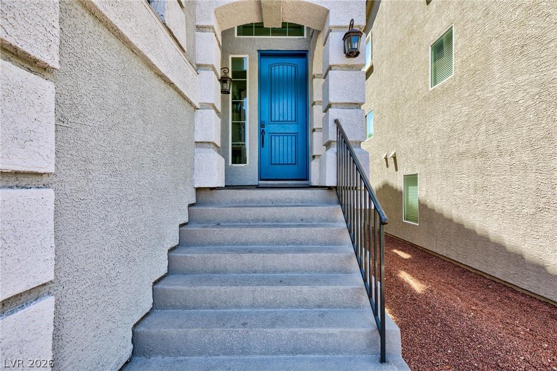 Image 3: A striking blue door welcomes visitors up concrete