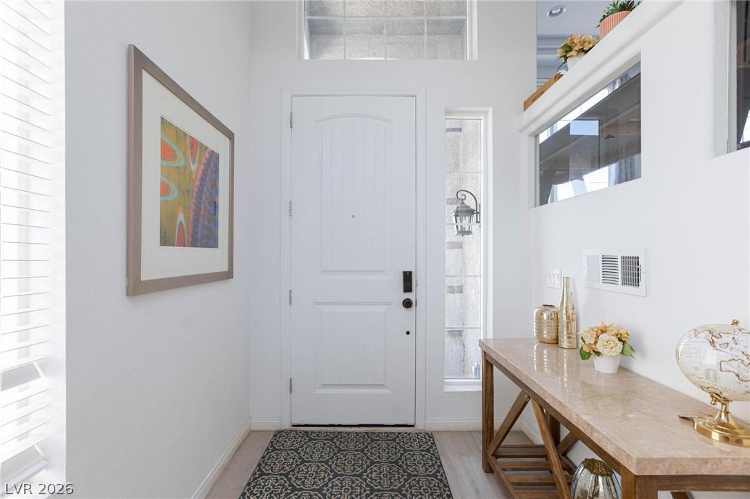 Image 4: A welcoming entry hall with a white door and decor