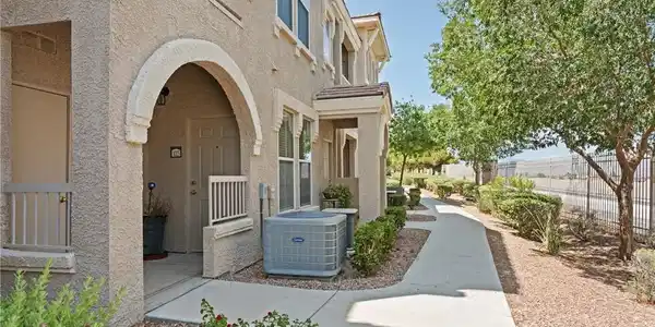 Image 2: A welcoming entry with warm stucco and functional