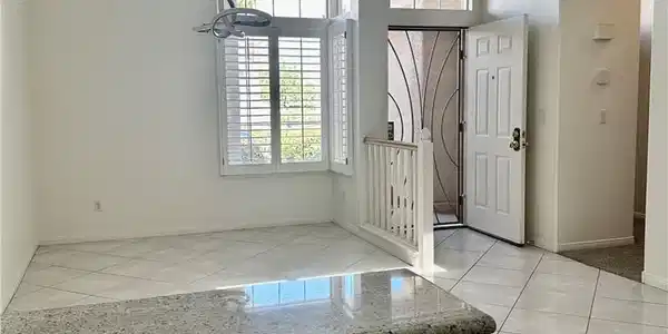 Image 3: Polished tile flooring and high ceilings welcome g