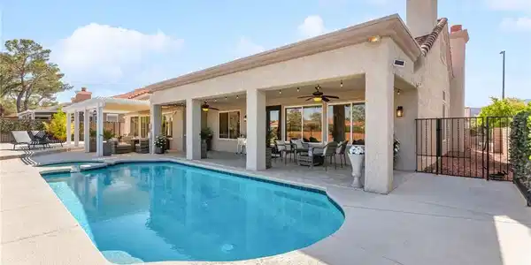 Image 4: An inviting backyard oasis awaits with a sparkling