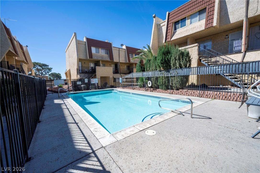 Image 4: Community pool with a patio area