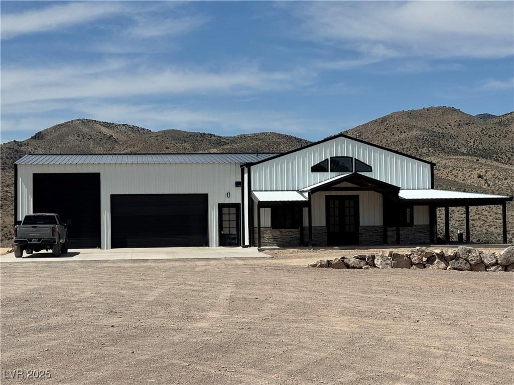 Image 1: View of front of property featuring a mountain vie