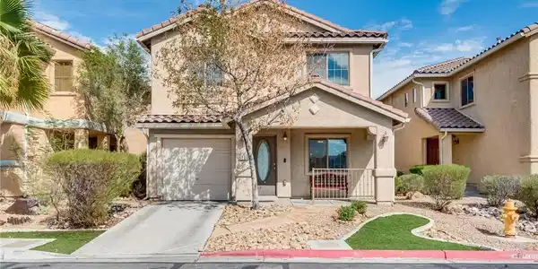 Image 2: Two-story stucco architecture is complemented by a