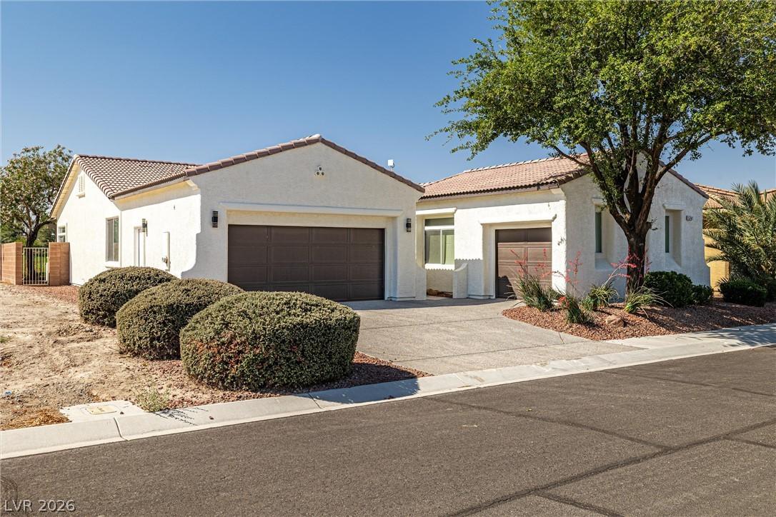 Image 1: A well-maintained stucco exterior and concrete dri