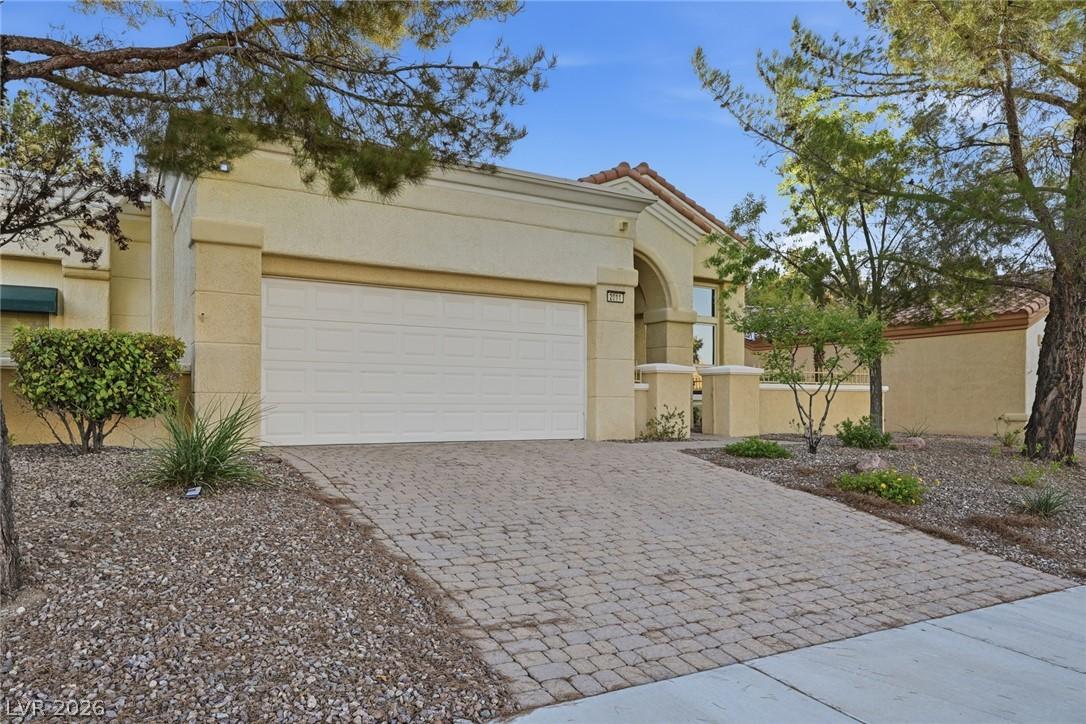 Image 2: A paver driveway and desert landscaping complement