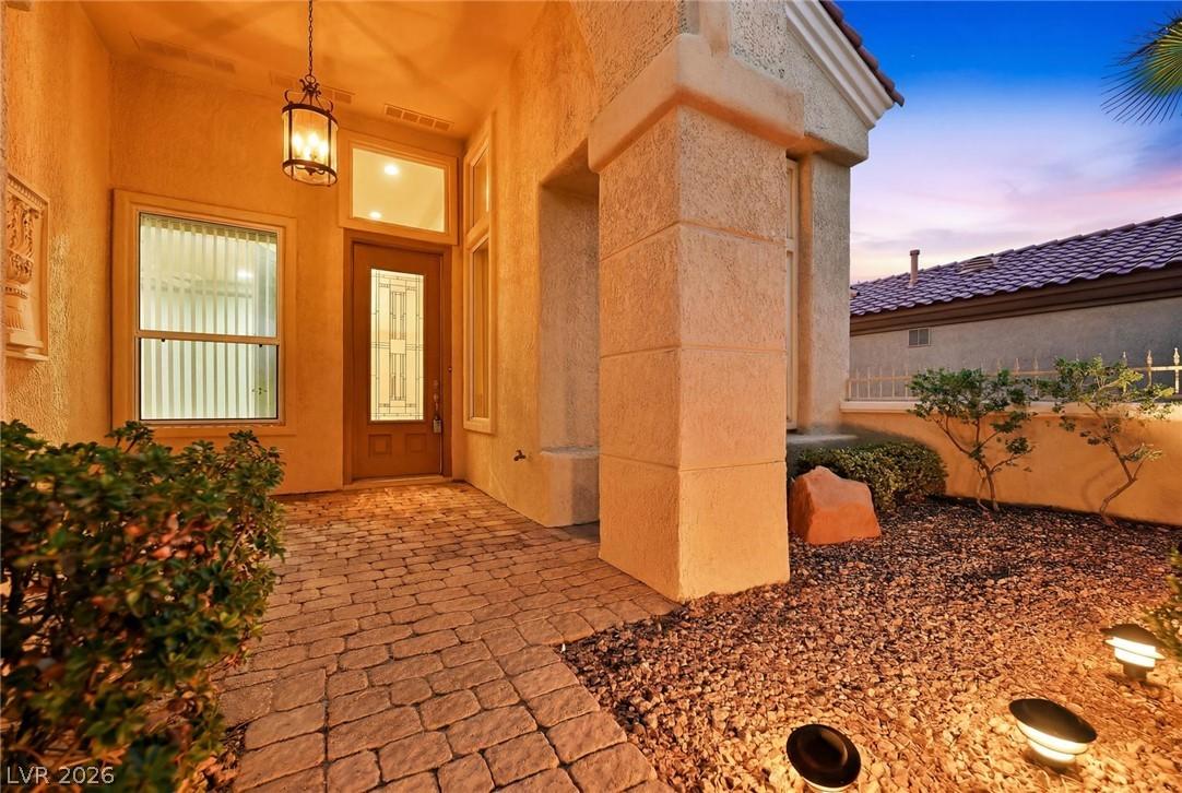Image 3: An inviting entry with an illuminated paver walkwa