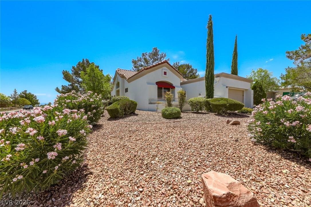 Image 2: A charming stucco residence with a red tile roof a