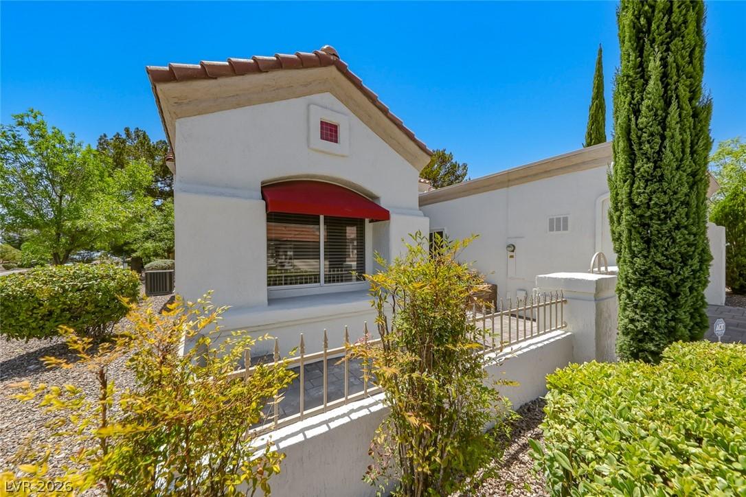Image 3: A charming exterior with a red awning and well-mai