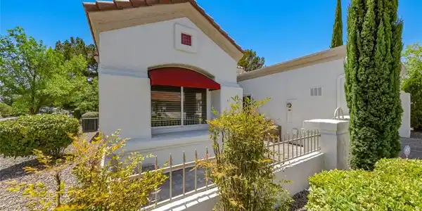 Image 3: A charming exterior with a red awning and well-mai