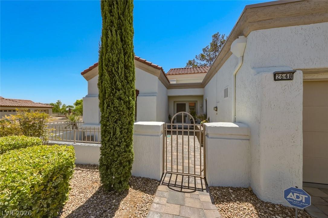 Image 4: A charming stucco exterior welcomes with a secure