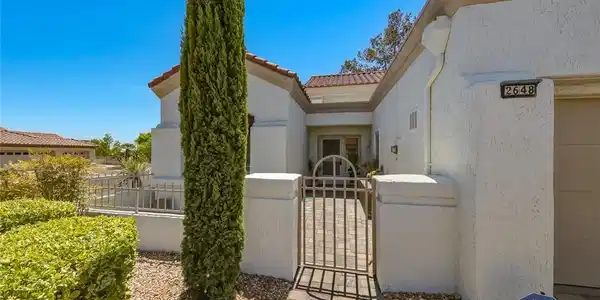 Image 4: A charming stucco exterior welcomes with a secure