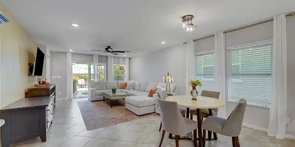 Image 3: Large tile flooring anchors this open living space