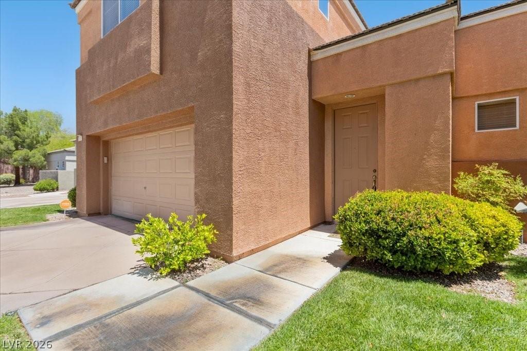 Image 3: A terracotta-hued stucco residence presents a sing