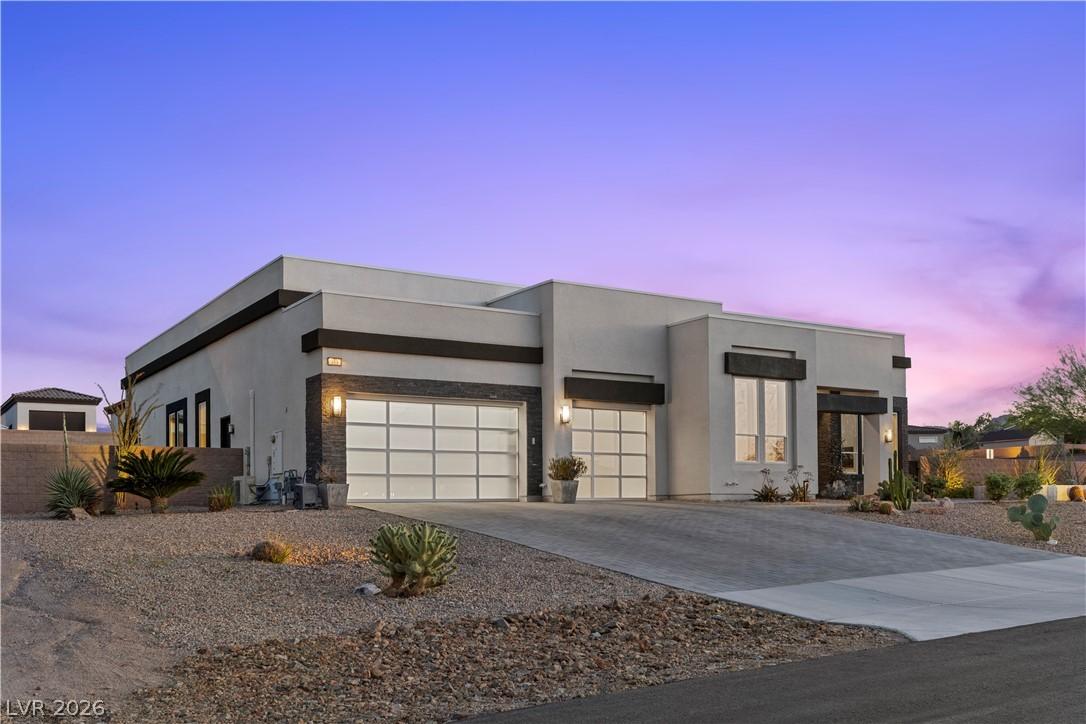 Image 2: This modern home features clean lines and a desert