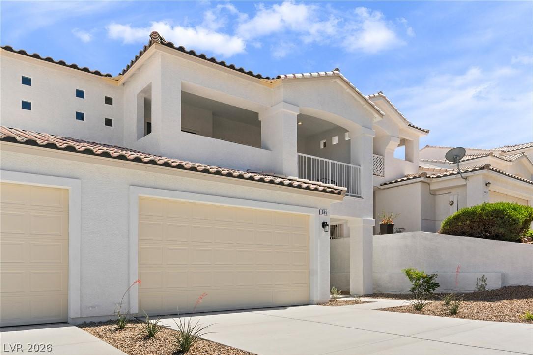 Image 3: A striking stucco facade with tile roofing offers
