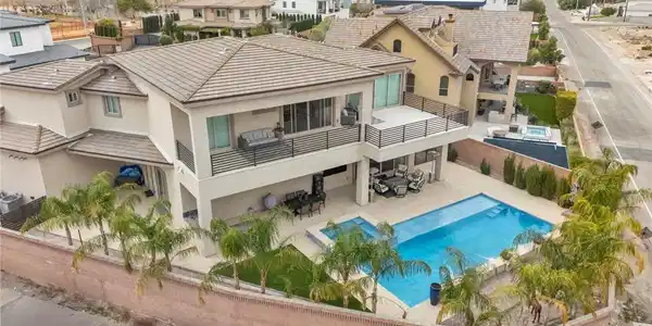 Image 3: Back of property featuring outdoor dining space, a