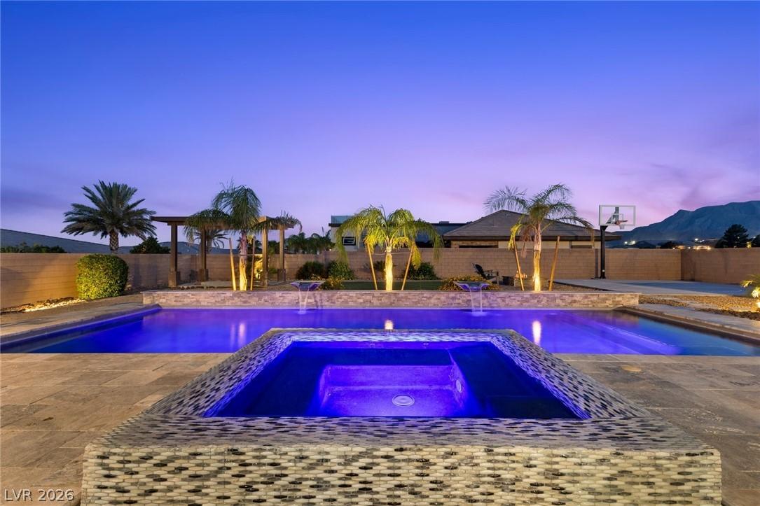 Image 2: An inviting backyard oasis offers a sparkling pool