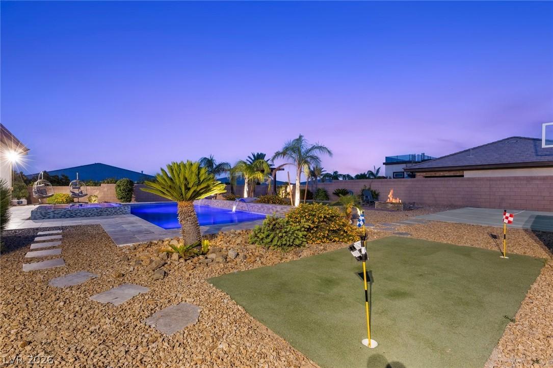 Image 3: An illuminated backyard retreat with a glistening