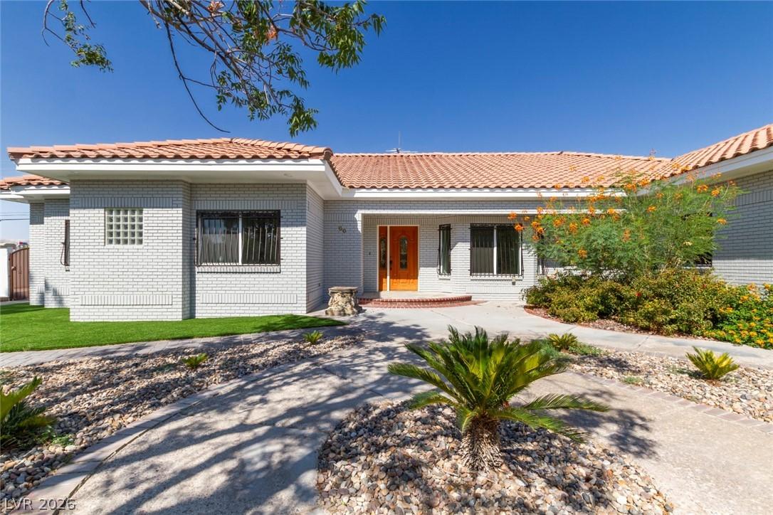 Image 3: This charming home features a brick exterior and a
