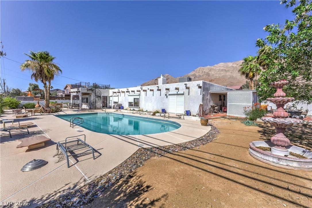 Image 2: An inviting backyard oasis offers a sparkling in-g