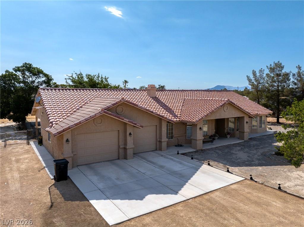 Image 1: A spacious home with a tiled roof offers ample par