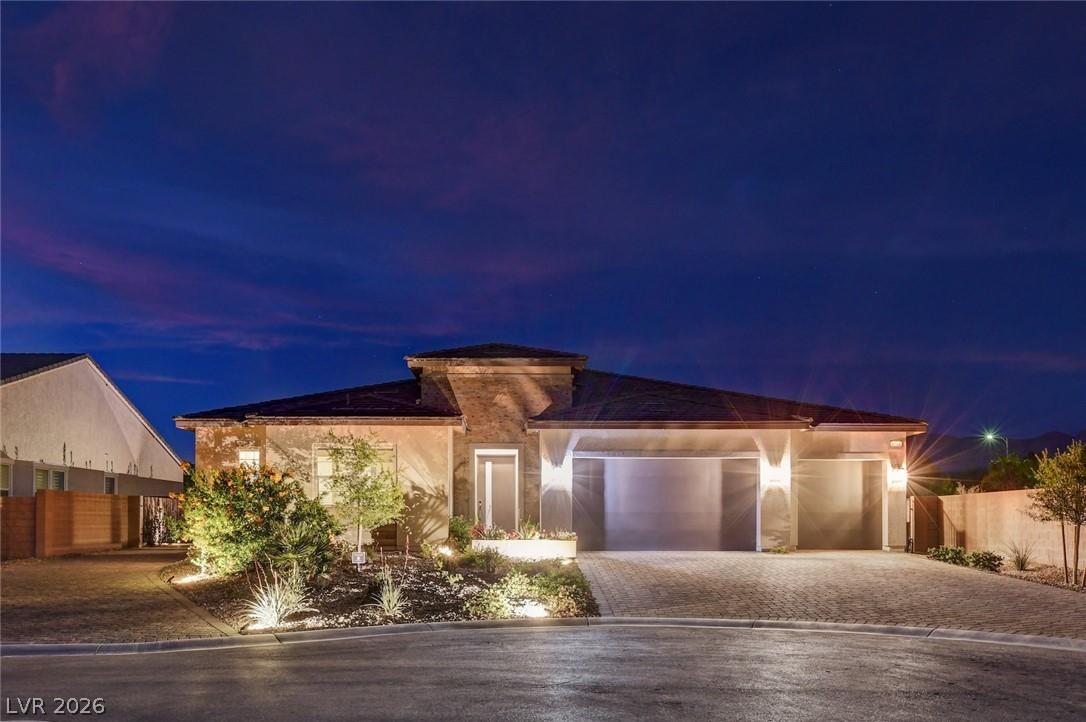 Image 2: Illuminated landscaping highlights the elegant fac