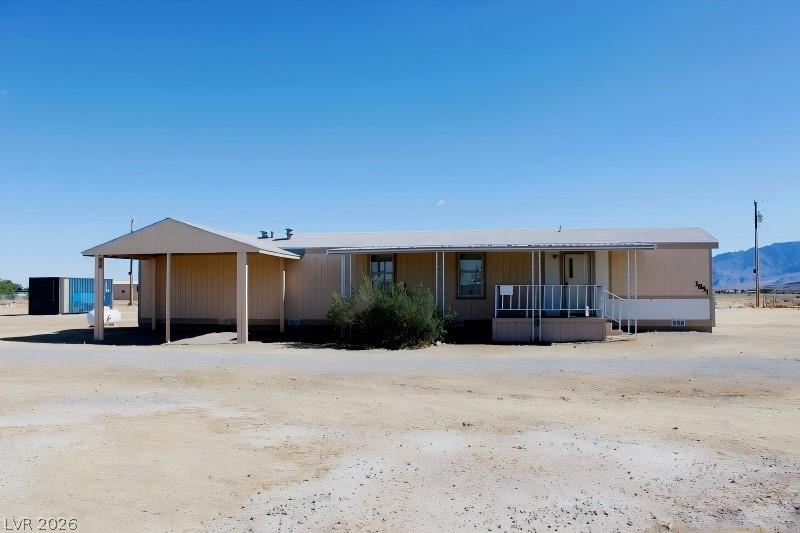Image 2: This home features a carport and covered porch, pe