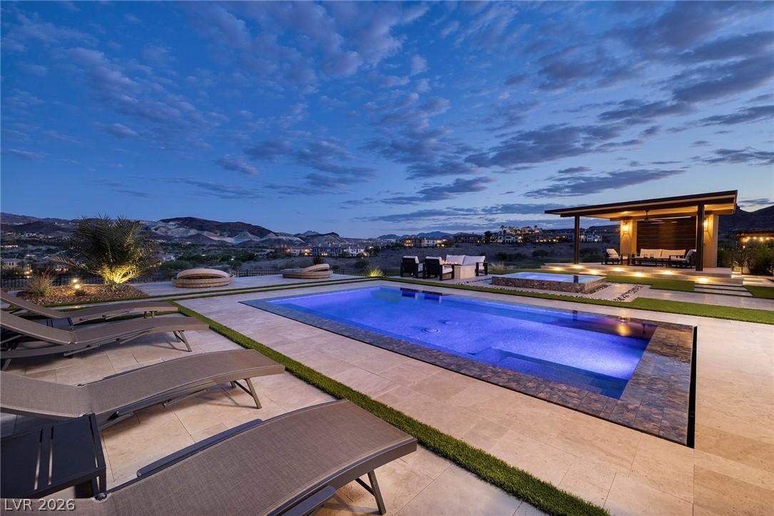 Image 3: An inviting backyard oasis features a glistening p