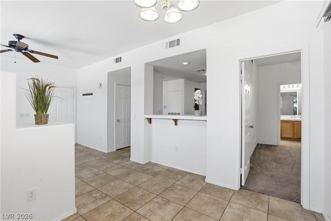Image 4: This bright interior features practical tile floor
