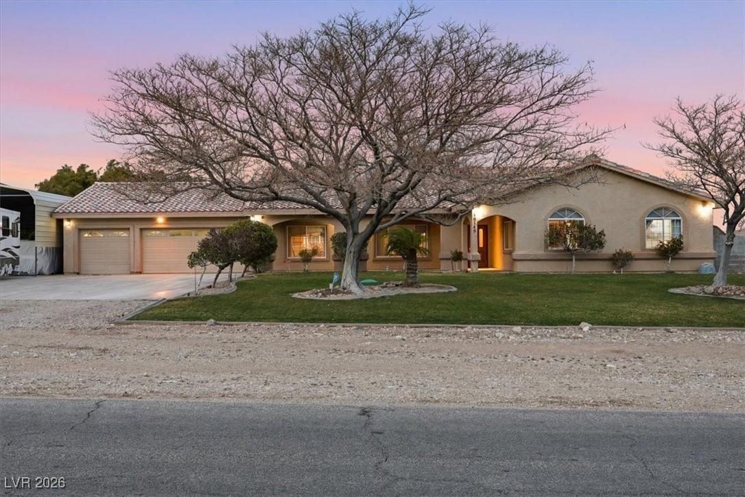 Image 1: View of front facade with a front yard, stucco sid