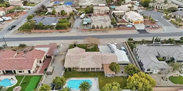 Image 4: Aerial perspective of suburban area with a pool
