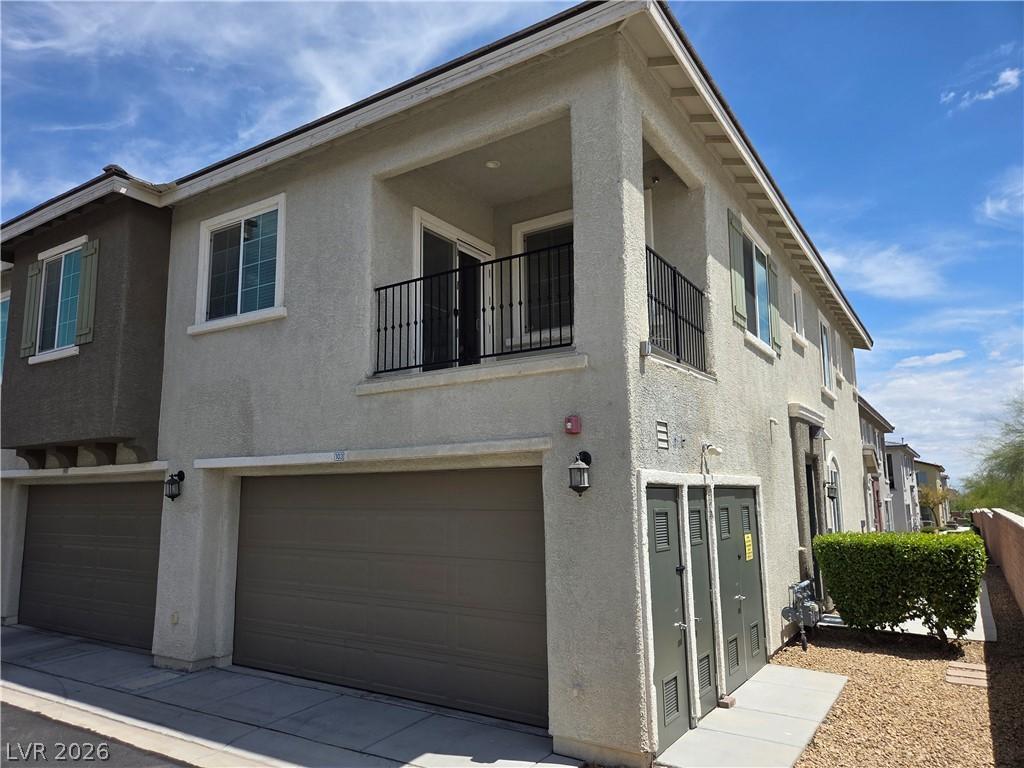 Image 1: This multi-story dwelling features garages and a c