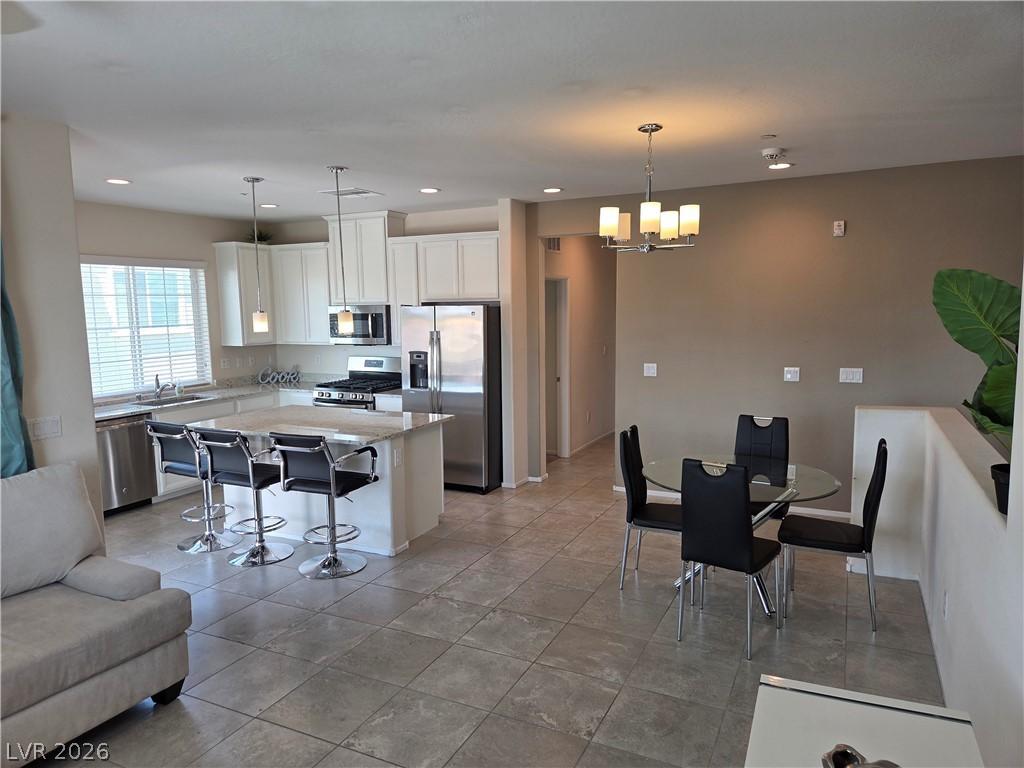 Image 4: This open concept kitchen and dining area provides